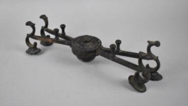 An Early Patinated Bronze Burner Stand with Hinged Scrolled Supports, 27cms Diameter