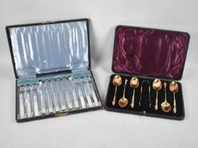 A Cased Set of Six Gilt Apostle Spoons and Matching Bow together with a Cased Set of Six Silver