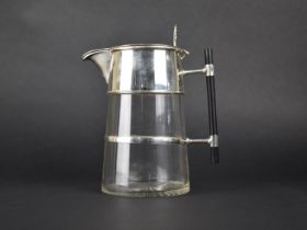 A Reproduction Arts and Crafts Style Silver Plated and Glass Lidded Jug with Ebonized Handle, 24.