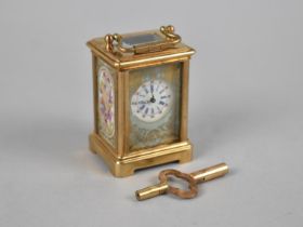 A Reproduction Miniature Gilt Brass and Sevres Style Porcelain Panel Carriage Clock, With Key and