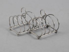 A Pair of Edwardian Silver Four Slice Toast Racks on Ball Feet