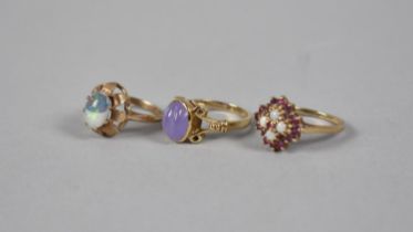 A Collection of Three Jewelled 9ct Gold Rings to include Ruby and Opal, Opal Cabochon in Floral