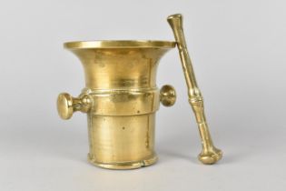 A Brass Two Handled Pestle and Mortar, 11.5cms Diameter and 12.5cms High