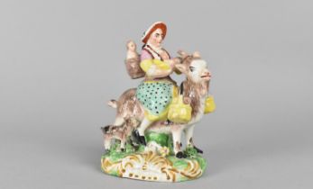 A Staffordshire Type Figure Group, The Tailor's Wife Riding Goat, 13cm high