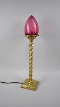 An Edwardian Brass Barley Twist Table Lamp with Cranberry Glass Shade, 68cms High