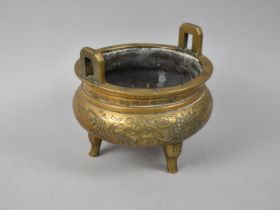 A Polished Bronze Chinese Two Handled Censer with Three Feet and Engraved Decoration to Body,