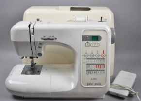 A Modern John Lewis Electric Sewing Machine with power lead and foot control