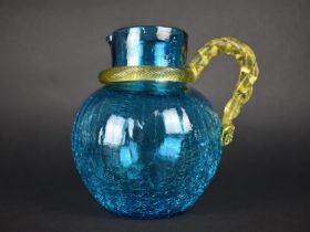 A Blue Crackle Glass Jug with with Yellow Interlaced Reeded Handle, 18.5cm high