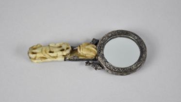 A Chinese Hand Mirror Mounted in White Metal Having Dragon Relief Decoration, the Handle Formed From