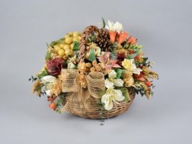 A Wicker Basket containing Artificial Flowers and Fruit
