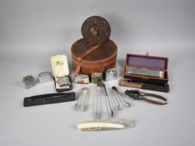 A Collection of Sundries to include Pocket Lighters, Bakelite Tape Measure, Harmonica, Leather