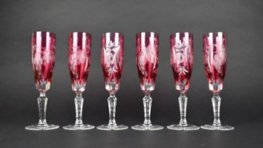 A Set of Six Overlaid Cranberry Glass Champagne Flutes, 22cm high