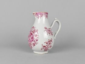 An 18th Century Porcelain Jug Decorated in Pink with Flowers, 15cm high, Condition Issues