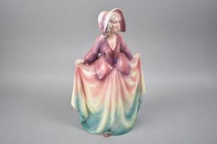 A Large Glazed Continental Figure of a Maiden, 31cms High