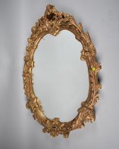 A Mid/Late 20th Century Gilt Framed Oval Wall Mirror of Ornate Form, 63cms by 47cms Overall