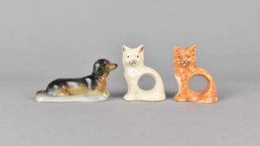 Two Whealdon Pottery Napkin Rings Modelled as Cats Together with a Branksome Study of a Dachshund