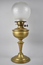 An Early 20th Century Brass Oil Lamp with Twin Controls and Etched Globe Shade, Overall Height 55cms