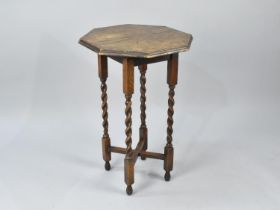 An Edwardian Oak Octagonal Topped Occasional Table with Barley Twist Supports, 51cms Diameter