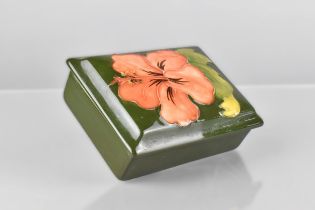 A Moorcroft Rectangular Lidded Box, Hibiscus Pattern on Green Ground 12x9x4cm High