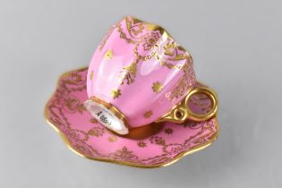 A Coalport Miniature Cabinet Cup and Saucer Decorated with Gilt Jewelling and Swags on Pink