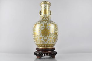 A Chinese Porcelain Celadon Ground Twin Handled Vase of Bottle Form Profusely Decorated in Gilt