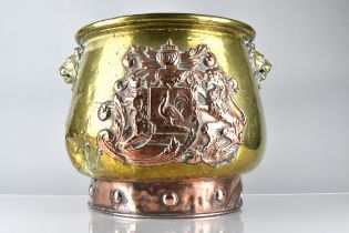 A Brass and Copper Log Bin/Coal Bucket with Heraldic Crest ad Lion Mask Handles, 33.5cms High