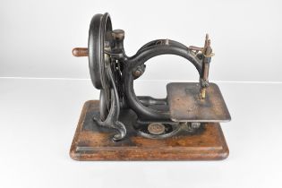 A Late 19th Century Willcox and Gibbs Sewing Machine Co, Hand Cranked Sewing Machine On Wooden