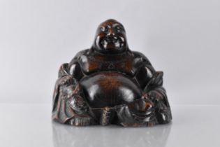 A 19th Century Chinese Carved Hardwood Seated Buddha with Inlaid Silver Wire Decoration, 15cm wide