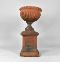 A Terracotta Garden Urn on Plinth Base of Campagna Form, the Urn with Moulded Leaf Design Rim Over