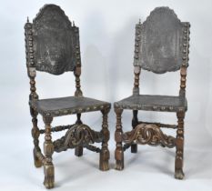 A Pair of 17th Century Walnut Hall Side Chairs with Studded Embossed Leather Backs, carved