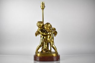 A Bronze Figural Lamp Base Depicting Cupid and Cherubs in Arms on Naturalistic Base and Raised on