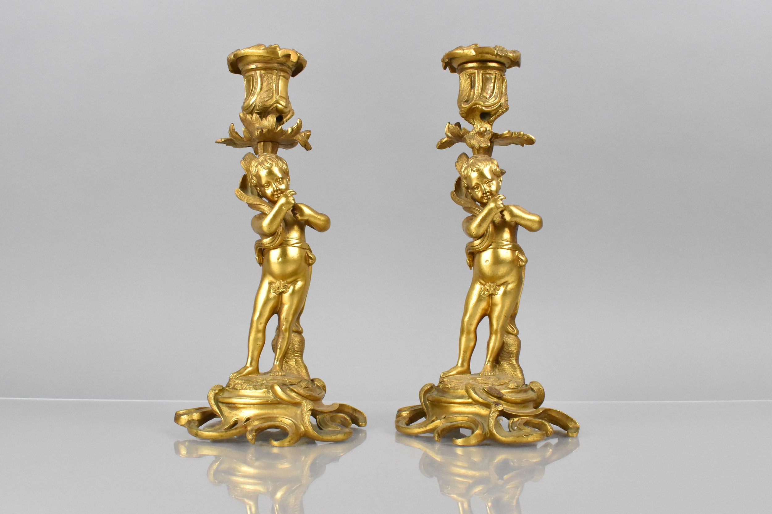 A Pair of 19th Century Gilt Bronze Candlesticks Modelled with Classical Cherubs Supporting