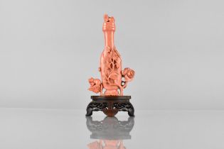 A Chinese Carved Coral Vase and Cover of Bottle Form Carved in Relief with Foliage 14cm 133g on