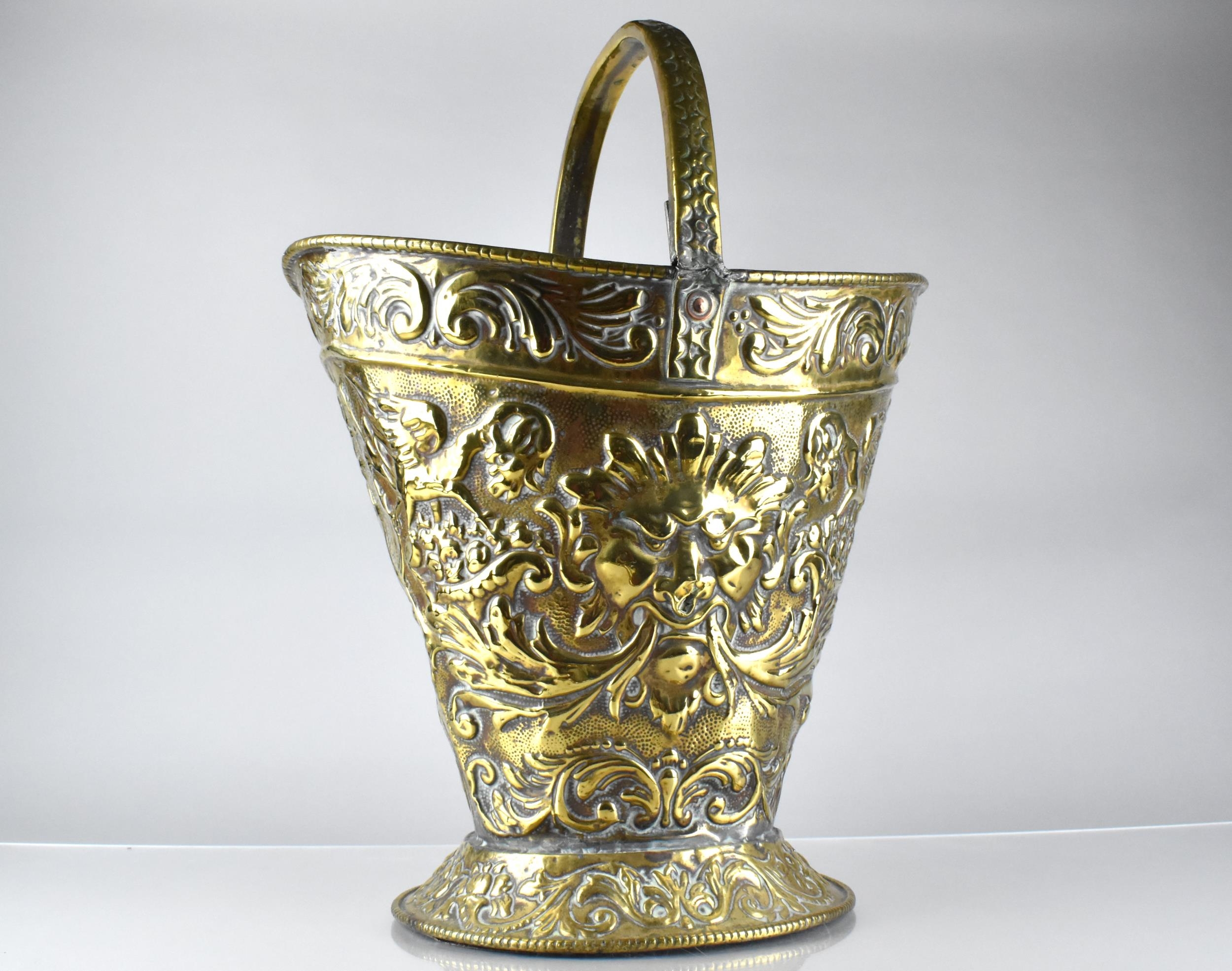 A 19th Century Brass Helmet Shaped Coal Bucket with Classical Embossed Decoration, Incorporating