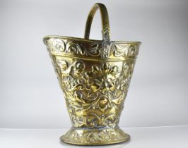 A 19th Century Brass Helmet Shaped Coal Bucket with Classical Embossed Decoration, Incorporating