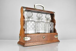 An Early/Mid 20th Century Oak and Silver Plate Mounted Three Bottle Tantalus, Complete with Key,