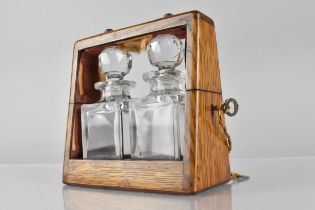 A Small Edwardian Oak Cased Two Bottle Tantalus with Keys, 14x7x14cms High