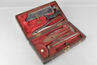 A 19th Century Mahogany Brass Mounted Surgeon's Field Amputation Kit by Coxeter. The Fitted Interior