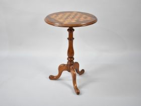 A Circular Tripod Games Table with Chess Board Top in Rosewood, Maple and Mahogany, 48cms Diameter