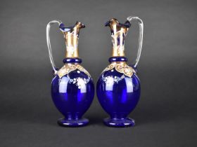 A Pair of Late Victorian/Edwardian Blue Glass Ewers Decorated in Gilt and Coloured Enamels, 24cm