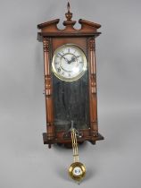 A Mahogany Cased Vienna Style Wall Clock, with Key and Pendulum