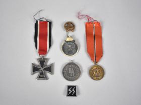 A Collection of Various Replica Nazi Badges and an Iron Cross