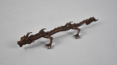 A Chinese Patinated Bronze Pen/Brush Rest in the Form of an Extended Dragon, 16cms Long