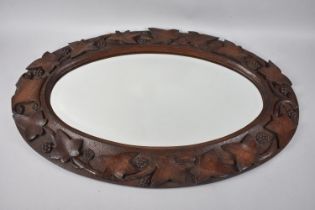 A Nice Quality Carved Oak Framed Oval Wall Mirror Decorated in High Relief with Vine Leaf and