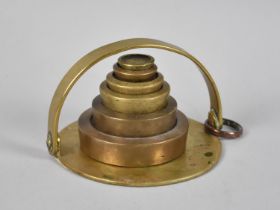 A Graduated Set of Six Brass Weights on Circular Stand