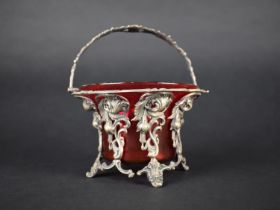 A Victorian Silver Plated Bowl Frame with Hinged Loop Handle Containing Cbranberry Glass Flared