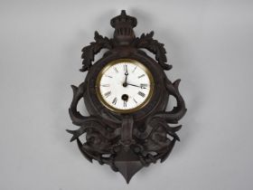 A Cast Metal Framed Wall Clock in the Form of a Heraldic Crest with Dolphins and Royal Motto