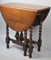 A Mid 20th Century Oak Barley Twist Drop Leaf Gate Leg Table with Oval Top, 73cms Wide