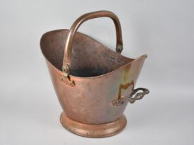A Vintage Copper Helmet Shaped Coal Scuttle with Loop Handle, 38cms High max