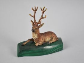 A Cold Painted Spelter Figure of a Reclining Stag Set on Malachite Plinth, 11cms Long